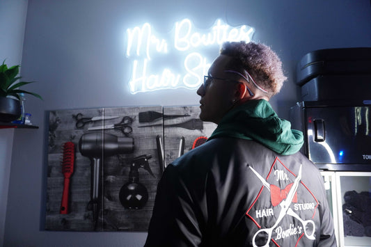 Mr. Bowtie's black bomber jacket with embroidered back logo